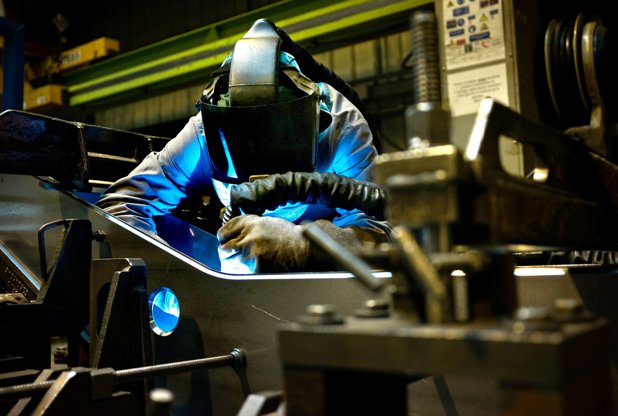 France, Alstom factory, man working at train bogie assembly line